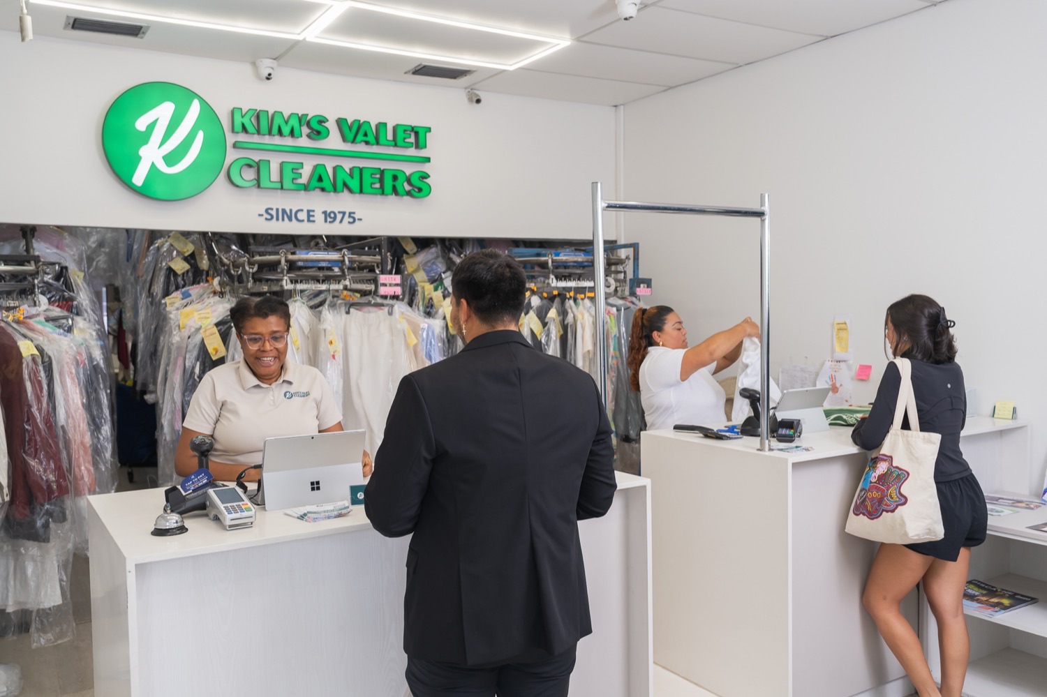 Kim's Valet Cleaners staff helping customers at the front counter