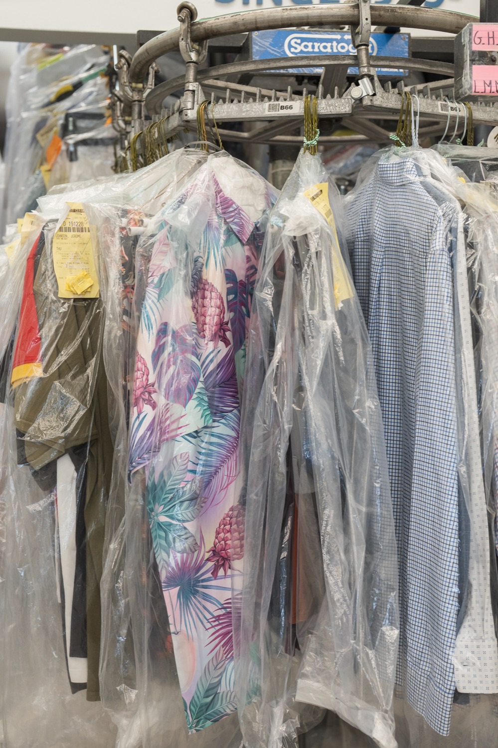 Freshly cleaned garments wrapped and hanging on the rail