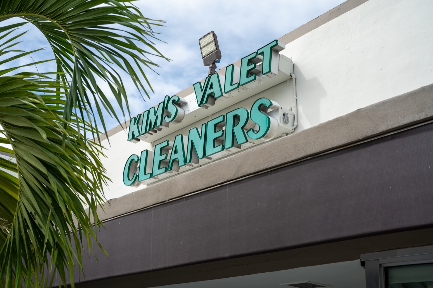 The Kim's Valet Cleaners storefront sign on Biscayne Blvd